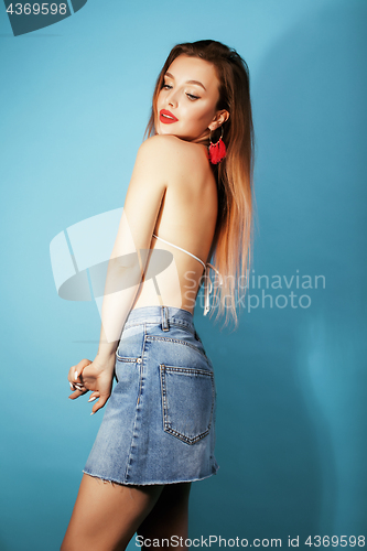 Image of young pretty brunette girl in bikini smiling studio blue background close up