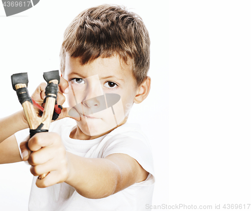 Image of little cute angry real boy with slingshot isolated