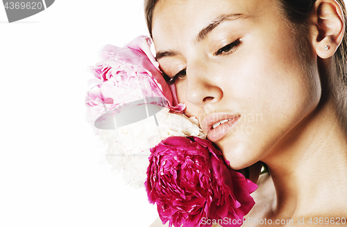 Image of young beauty woman with flower peony pink closeup makeup soft te