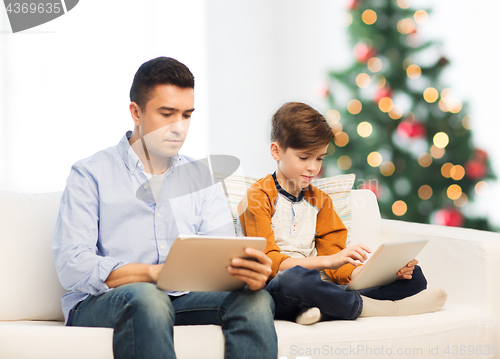 Image of father and son with tablet pc at christmas