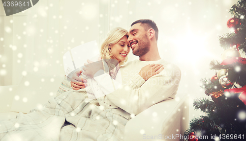 Image of happy couple at home with christmas tree