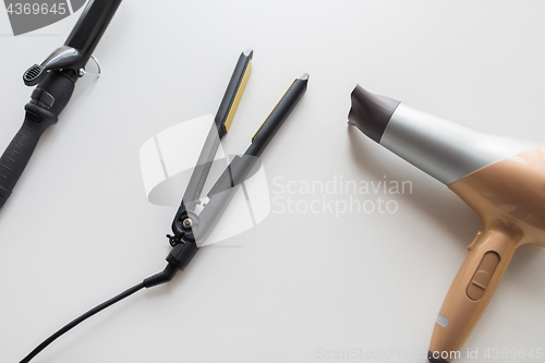 Image of hairdryer, hot styler and curling iron or tongs