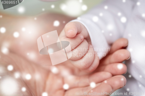 Image of close up of mother and newborn baby hands