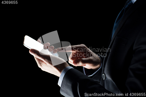 Image of close up of businessman with glass smartphone