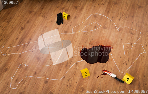 Image of chalk outline and knife in blood at crime scene