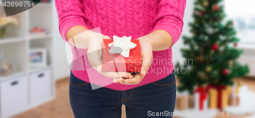 Image of close up of woman hands holding christmas gift