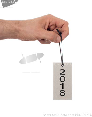 Image of Hand holding a tag - New year - 2018