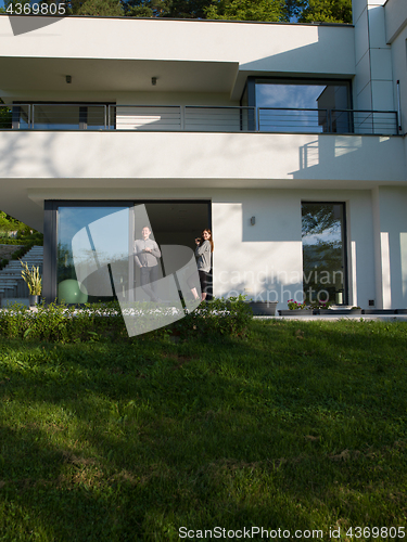 Image of couple enjoying on the door of their luxury home villa