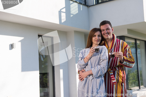 Image of Young beautiful couple in bathrobes