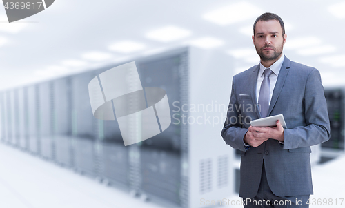 Image of Young businessman in server room