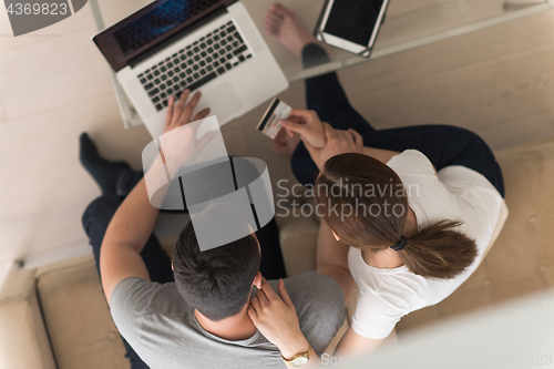 Image of happy young couple buying online