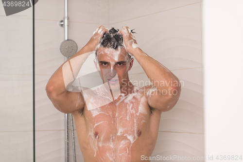 Image of man taking shower in bath