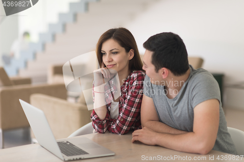 Image of happy young couple buying online