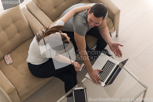 Image of happy young couple buying online