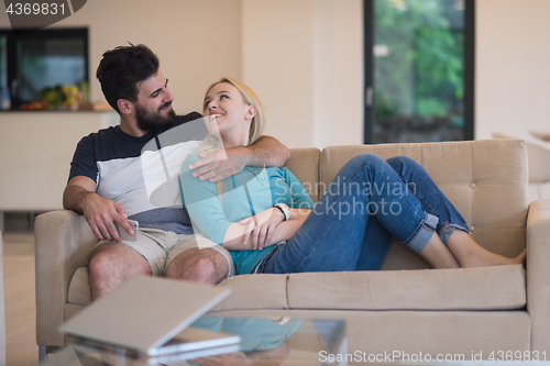 Image of young happy couple relaxes in the living room