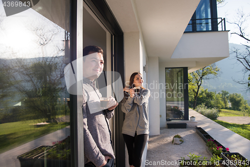 Image of couple enjoying on the door of their luxury home villa