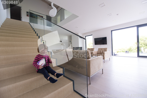 Image of little cute girl enjoying on the stairs