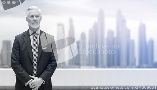 Image of Senior businessman in front of the big city