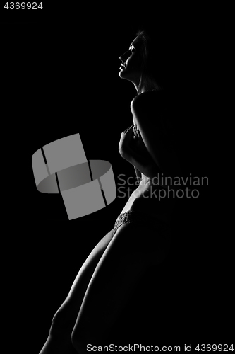 Image of Black and white silhouette of young, sporty and sexy woman in lingerie