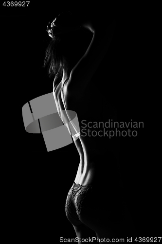 Image of Black and white silhouette of young, sporty and sexy woman in lingerie