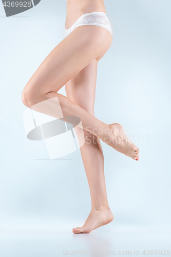 Image of Perfect female legs in underwear.