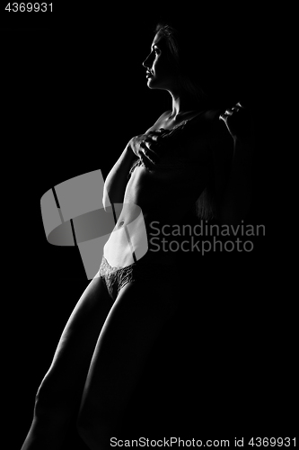 Image of Black and white silhouette of young, sporty and sexy woman in lingerie
