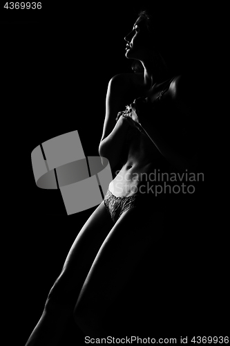 Image of Black and white silhouette of young, sporty and sexy woman in lingerie