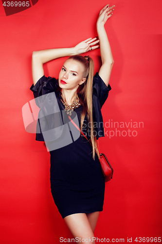 Image of young pretty woman young lady posing on red background, lifestyle people concept