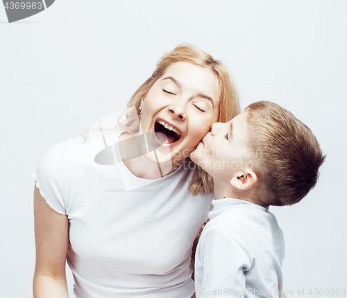 Image of young modern blond curly mother with cute son together happy smiling family posing cheerful on white background, lifestyle people concept, sister and brother friends