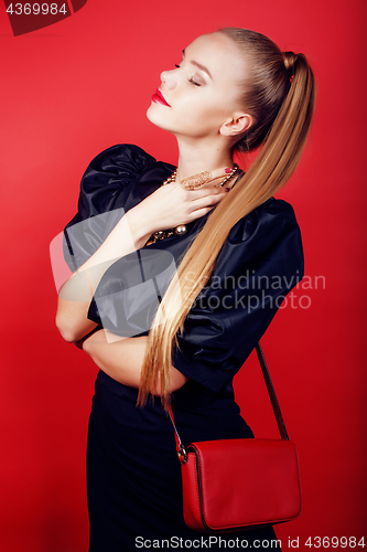 Image of young pretty woman young lady posing on red background, lifestyle people concept