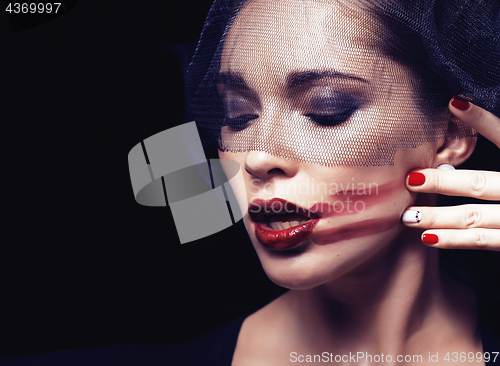 Image of beauty brunette woman under black veil with red manicure close up
