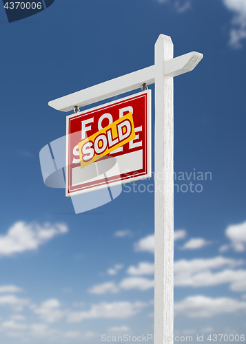 Image of Left Facing Sold For Sale Real Estate Sign on a Blue Sky with Cl