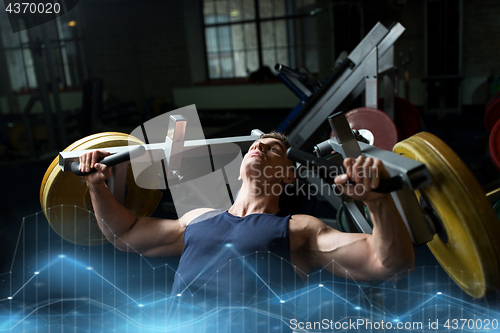 Image of man doing chest press on exercise machine in gym