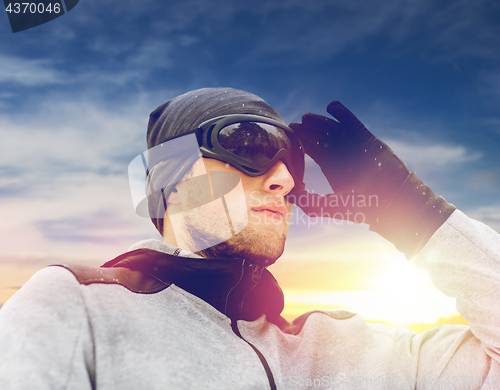 Image of sports man with ski goggles in winter outdoors