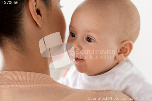 Image of close up of happy little baby boy with mother