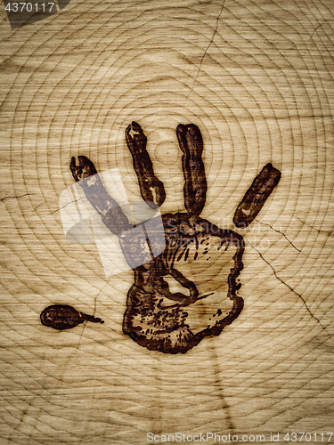 Image of wood with hand branding