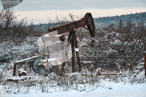 Image of Oil well on a winter landscape