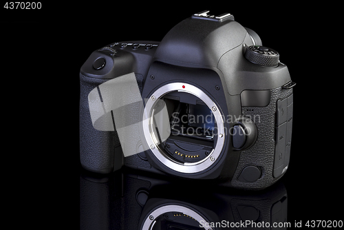 Image of Dslr camera frontal side on black glass