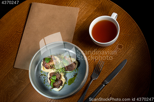 Image of Grilled steak with vegetables puree on plate.