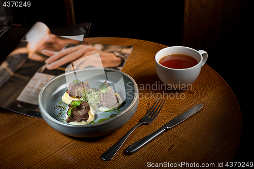 Image of Grilled steak with vegetables puree on plate.