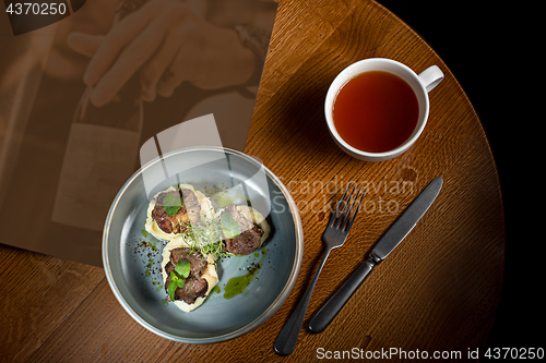 Image of Grilled steak with vegetables puree on plate.