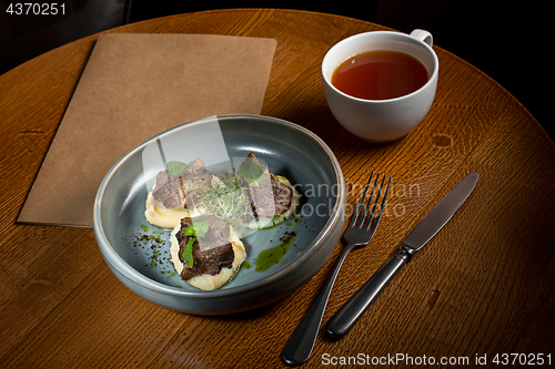 Image of Grilled steak with vegetables puree on plate.