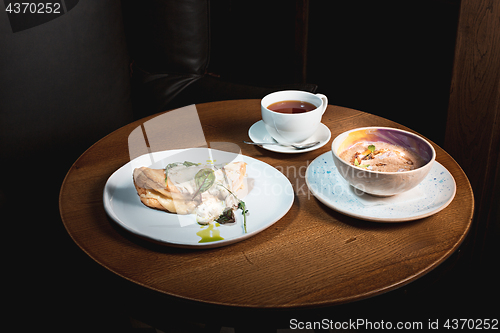 Image of closeup of a plate with a typical tortilla de patatas, spanish omelet, on a set table