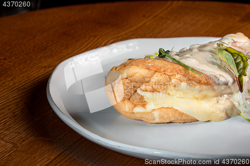 Image of closeup of a plate with a typical tortilla de patatas, spanish omelet, on a set table