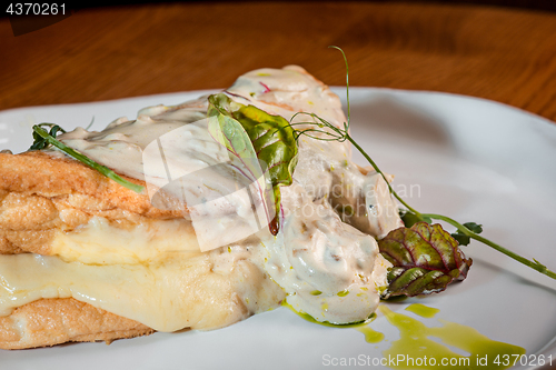 Image of closeup of a plate with a typical tortilla de patatas, spanish omelet, on a set table