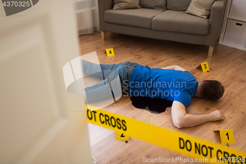 Image of dead man body in blood on floor at crime scene