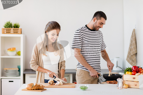 Image of couple cooking food at home kitchen