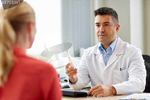 Image of doctor with nasal spray and patient at hospital