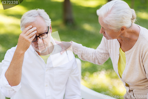 Image of senior man suffering from headache outdoors