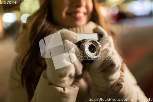 Image of close up of happy woman with camera at christmas